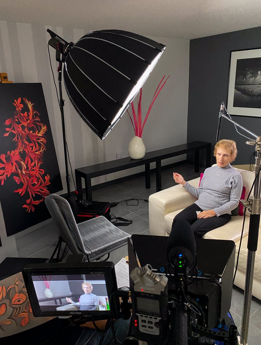 Behind the scenes of an on-camera interview with softbox lighting and a camera monitor